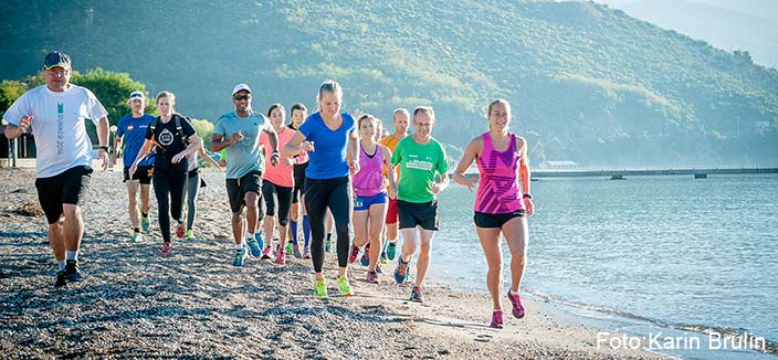 Springer på en strand i grupp, utomlands